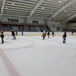 Children skating on an indoor ice rink