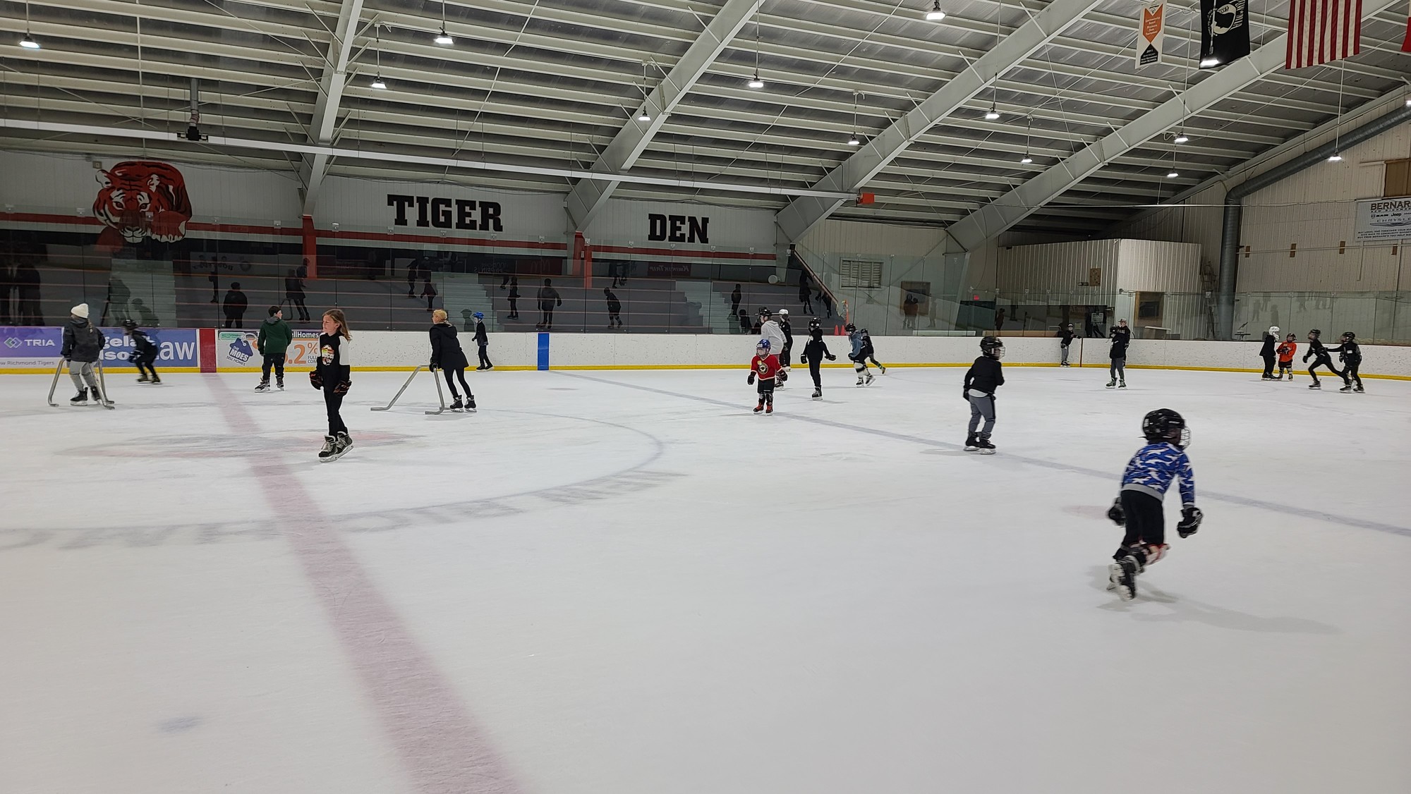 Children skating on an indoor ice rink