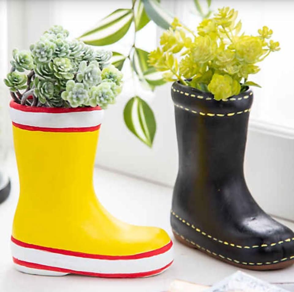 two painted planters shaped like rain boots.