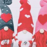 Three gnomes with red and white beards and valentine hats