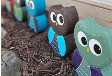 a row of painted pavers that look like owls