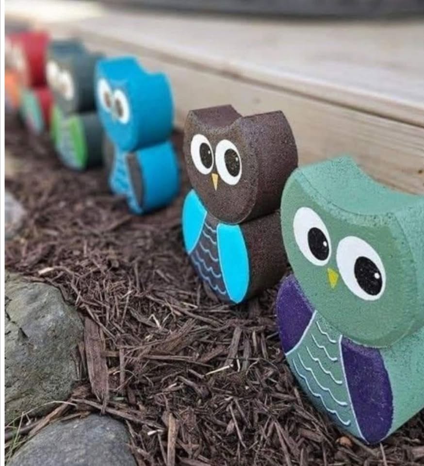 a row of painted pavers that look like owls