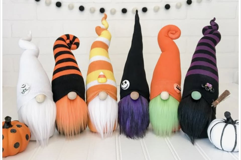 a row of crafted fall decorated gnomes