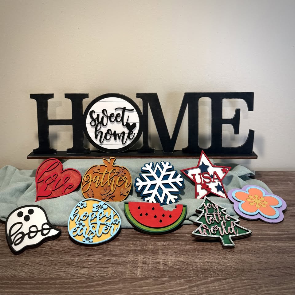 A pile of wall hanging signs, including "Home Sweet Home"