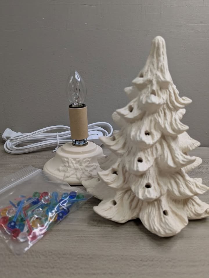 an unpainted ceramic christmas tree with a lightbulb base.