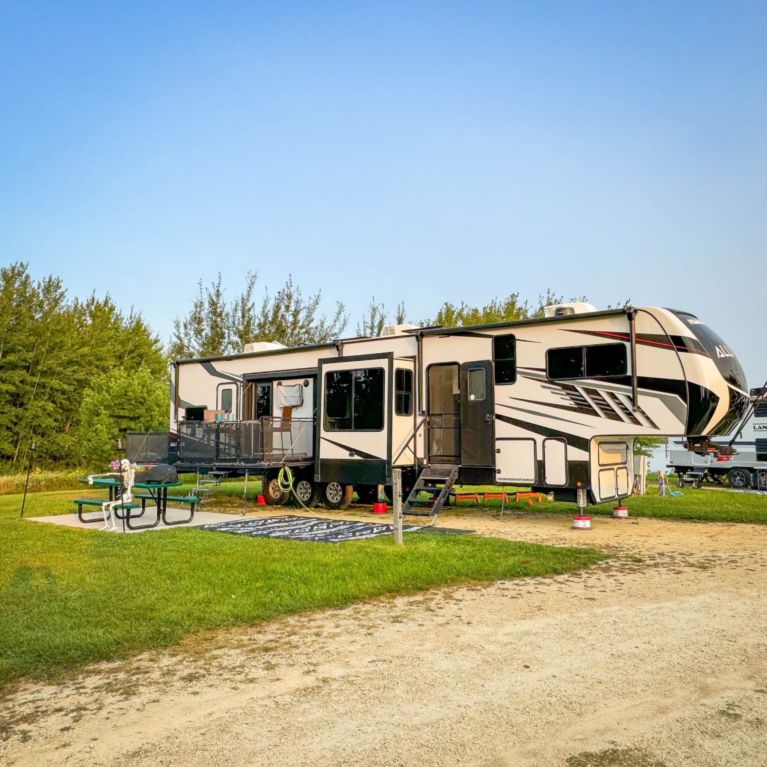 A camper in Hatfield park with a table in  front of it. 
