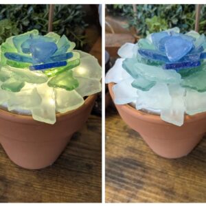 A picture of a light up sea glass planter with colorful colors being shown.