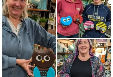 Women show their owls painted onto pavers