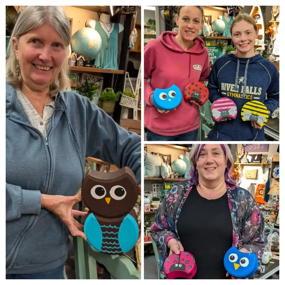 Women show their owls painted onto pavers