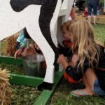 two children playing at a farm