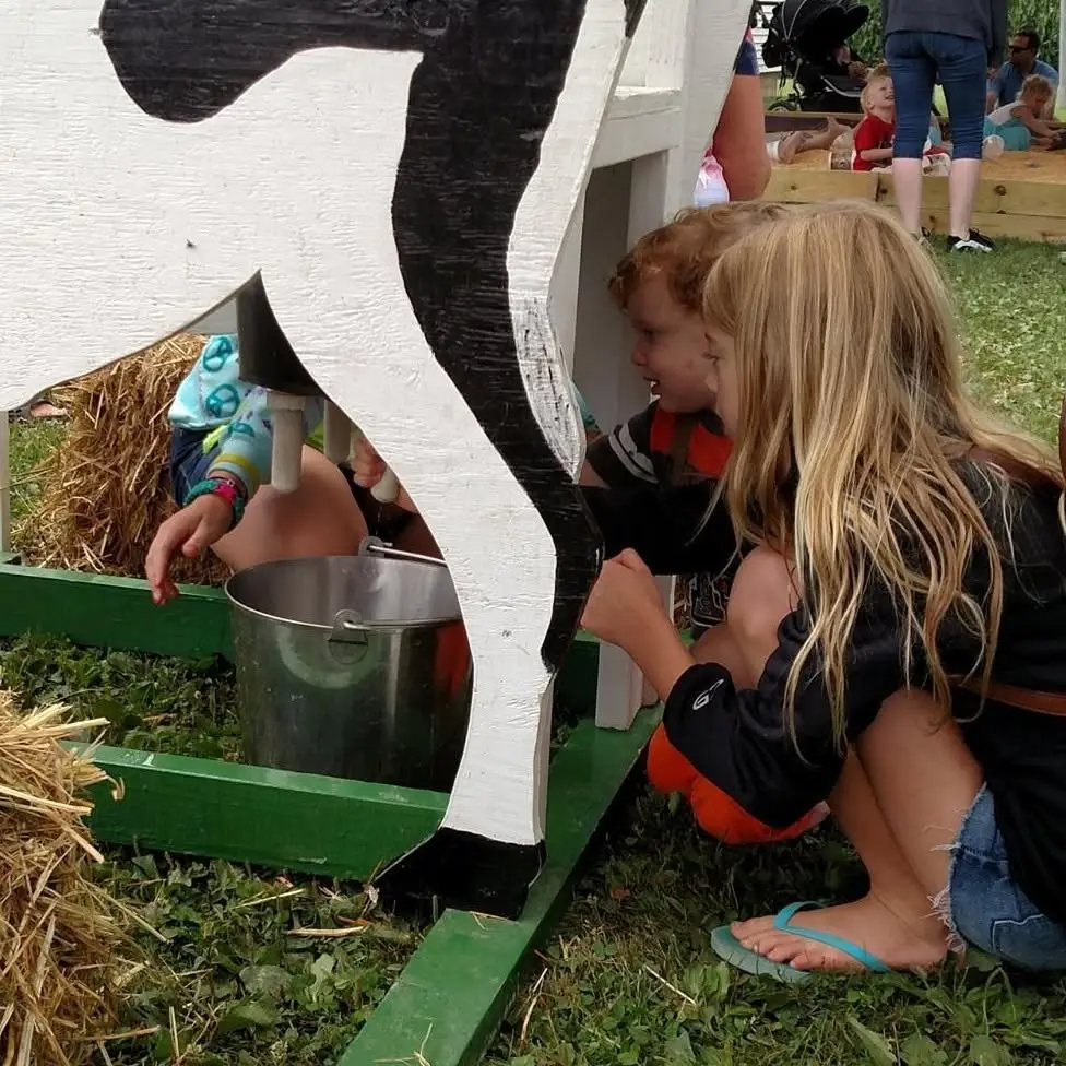 two children playing at a farm