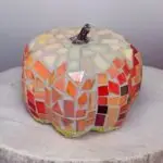 A 6 inch pumpkin covered in mosaic glass